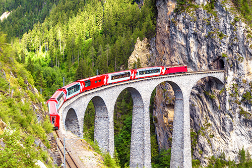 a train on a bridge rounds a corner