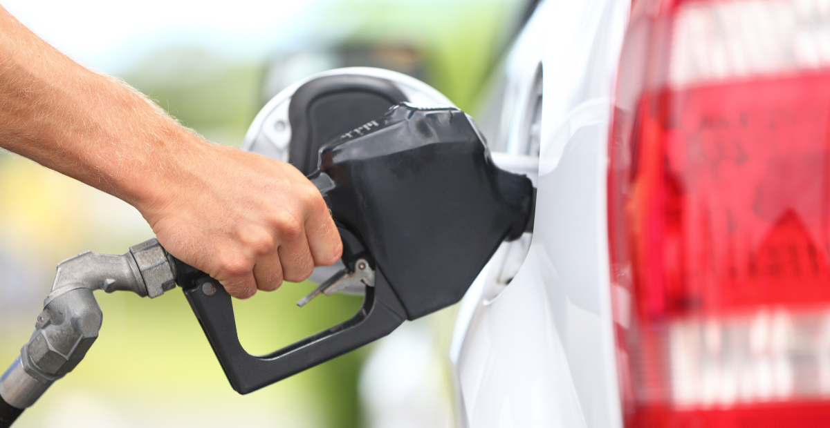 a close up shot of a person filling their car with gasoline