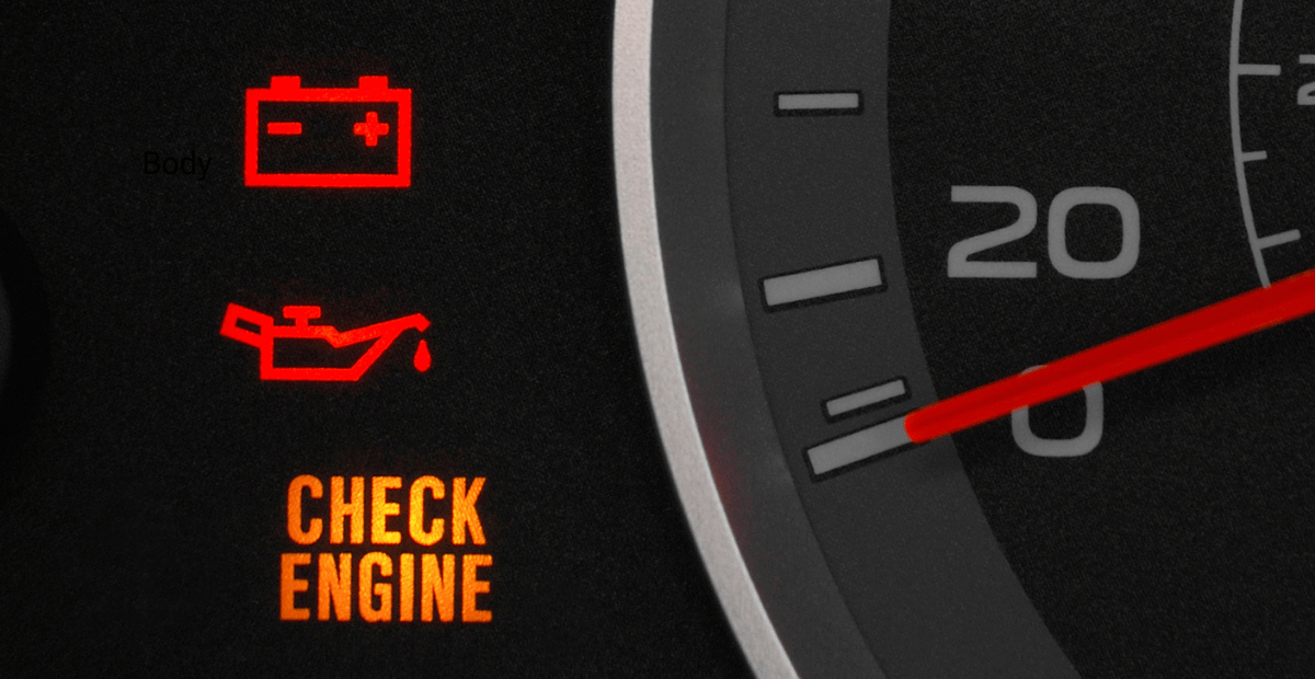 A close up of a car dashboard with warning lights illuminated