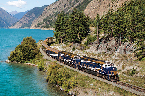 train rounding a bend near a river