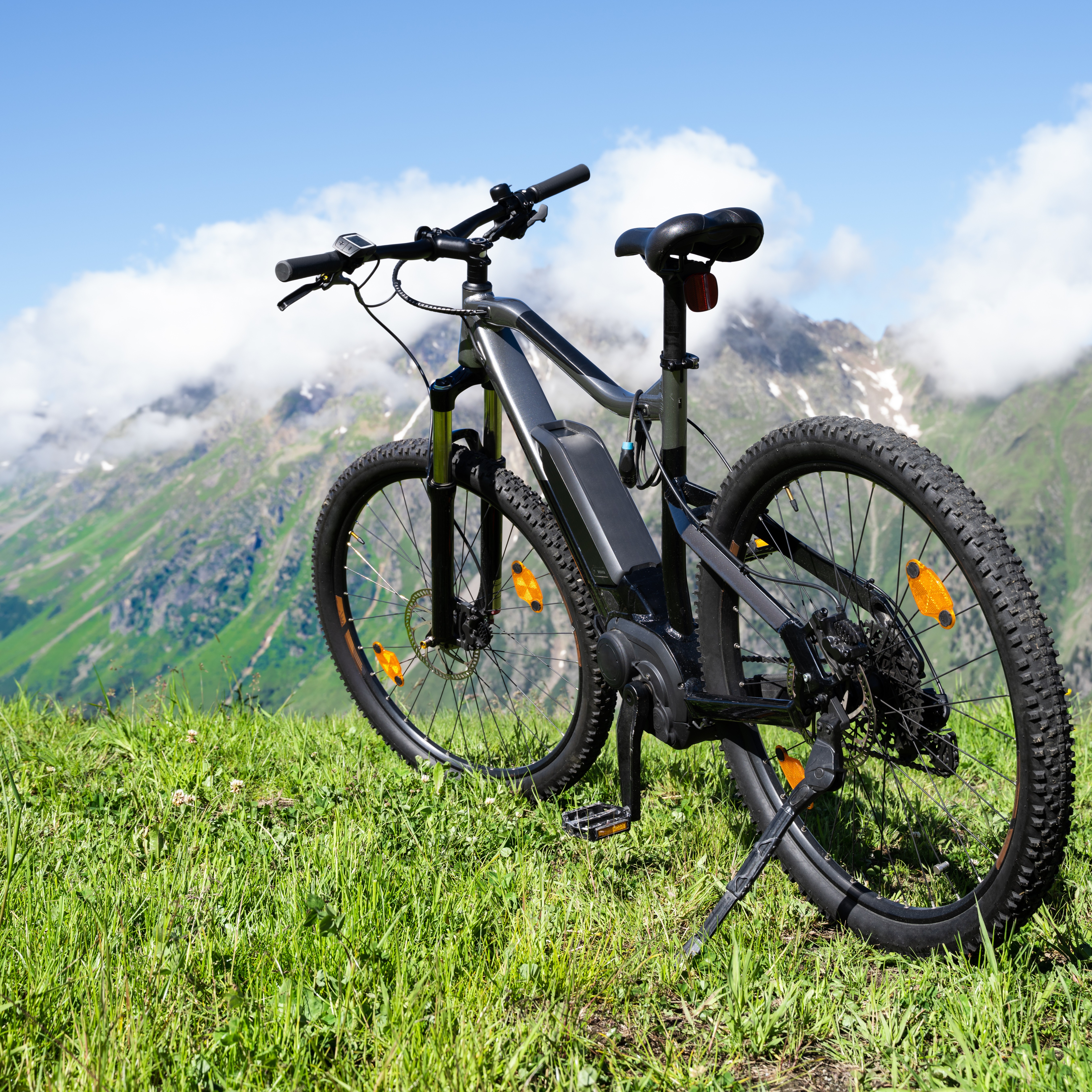 Adobe stock image of an electric bike in a field overlooking a scenic view of mountains.