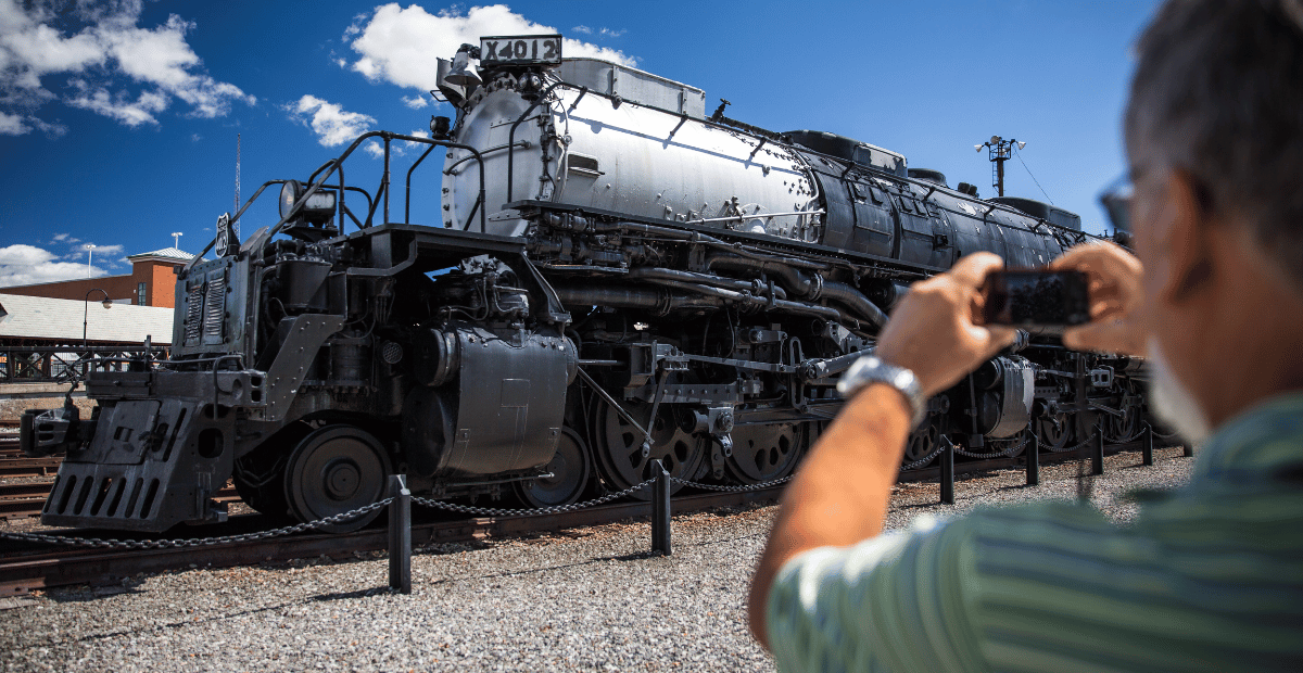 a man takes a photo of a Union Pacific Big Boy train