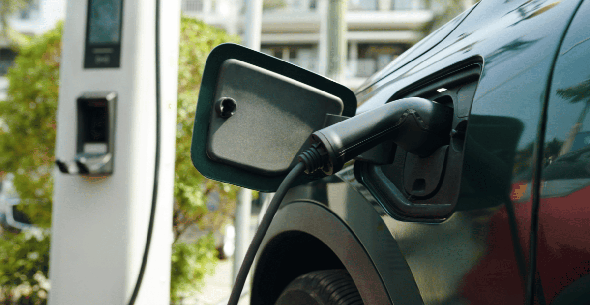 A close up of an electric car being charged