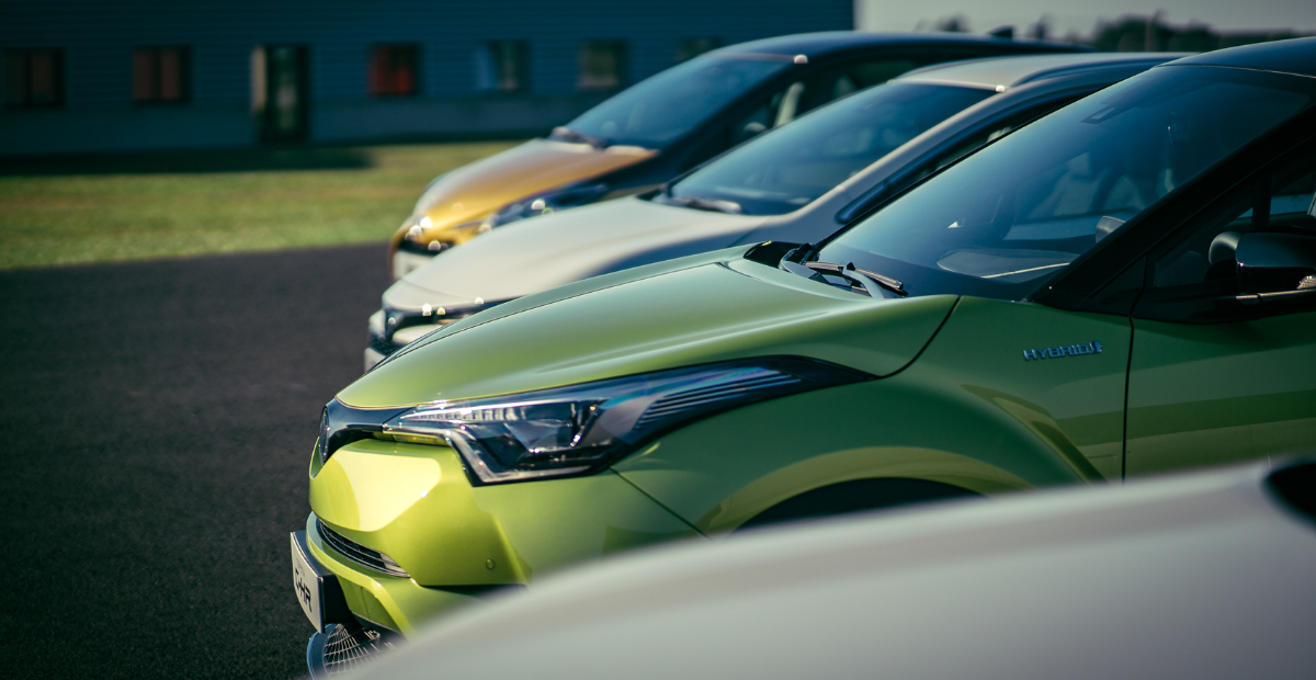close up of several new cars in a parking lot