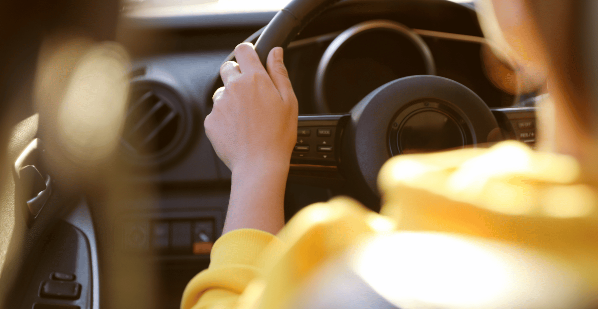 A driver behind the wheel of a car