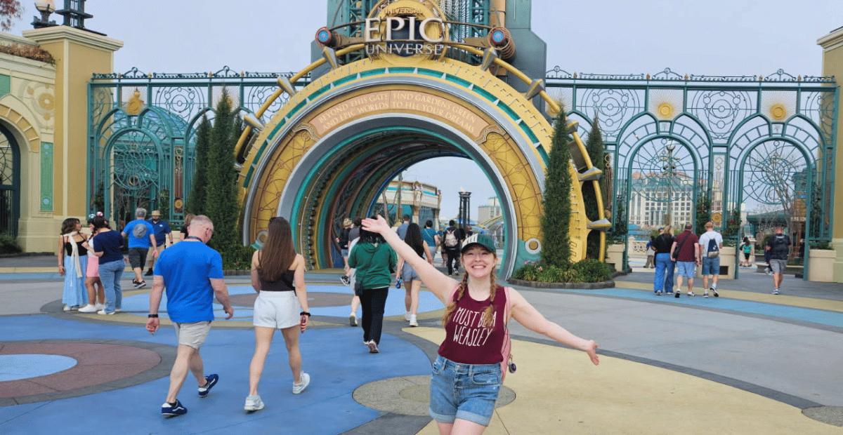 The author poses outside the main gate at Epic Universe theme park.