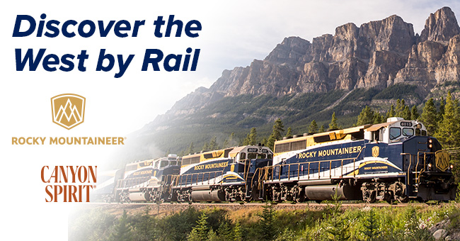 train in front of rocky mountains