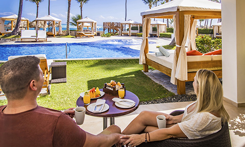 a couple eating breakfast at a beach front resort