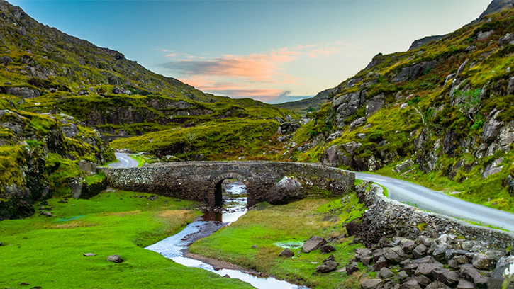 Small stone bridge in bright green Irish landscape