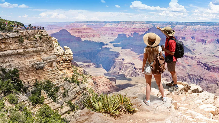 two people standing on edge of a western canyon