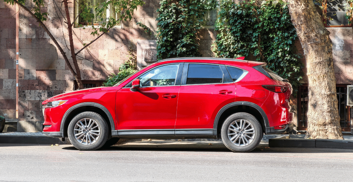 A red SUV on a city street